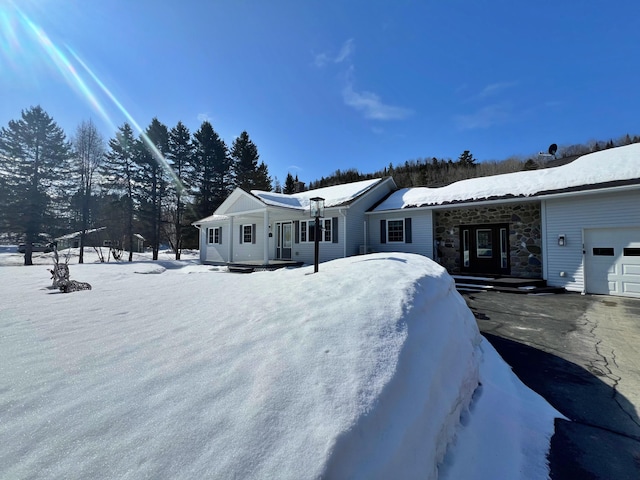 view of front of house featuring a garage and stone siding