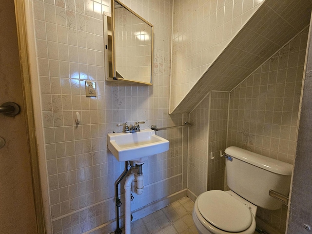 68 Boothby St, Augusta, ME 04330 - bathroom with tile walls, toilet, vaulted ceiling, and a sink