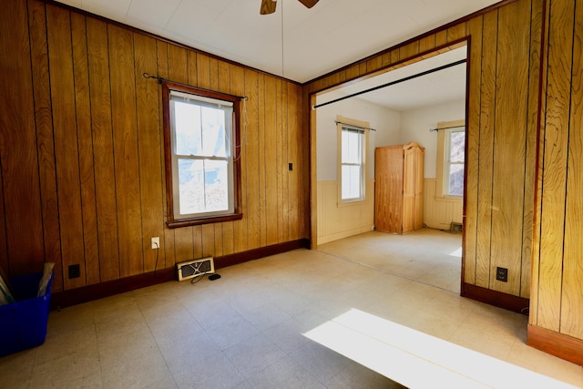 68 Boothby St, Augusta, ME 04330 - spare room featuring visible vents, wooden walls, baseboards, tile patterned floors, and a ceiling fan
