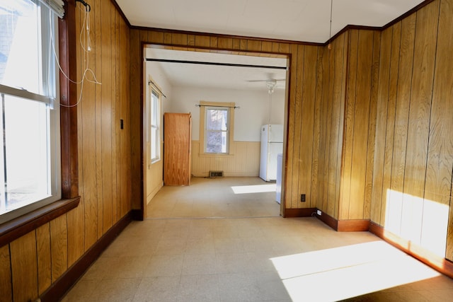 68 Boothby St, Augusta, ME 04330 - hallway with ornamental molding, wood walls, and light floors