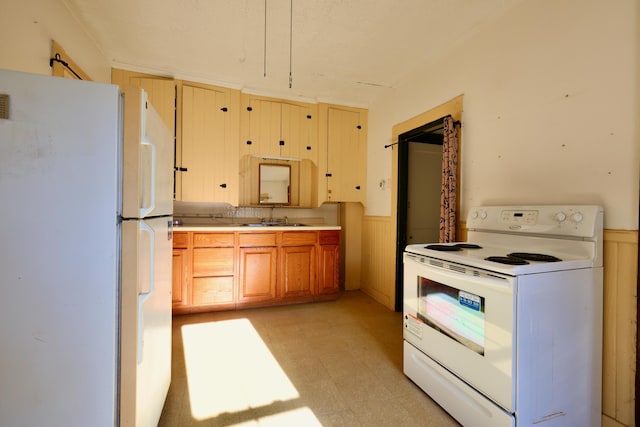 68 Boothby St, Augusta, ME 04330 - kitchen with a wainscoted wall, light countertops, white appliances, light floors, and a sink