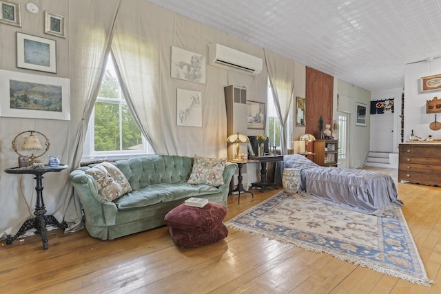 696 Bangor Rd, Troy, ME 04987 - living area featuring an AC wall unit and hardwood / wood-style floors
