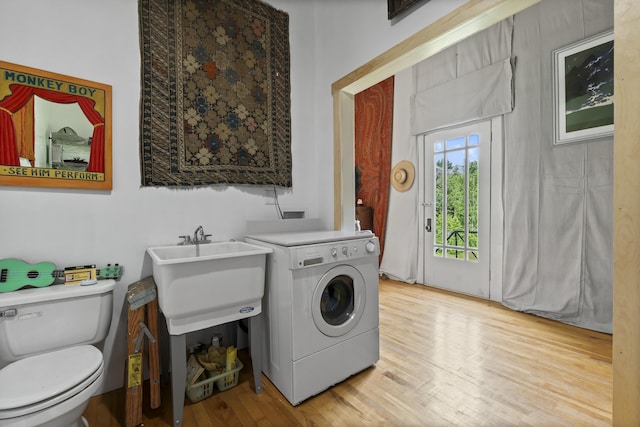 696 Bangor Rd, Troy, ME 04987 - laundry room with a sink, washer / dryer, light wood finished floors, and laundry area