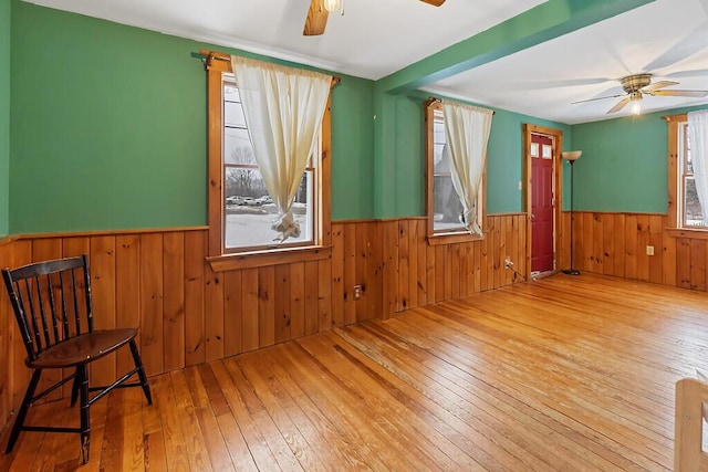 16 Libby Hill Rd, Gardiner, ME 04345 - spare room with a ceiling fan, wainscoting, hardwood / wood-style floors, and wooden walls