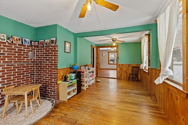 16 Libby Hill Rd, Gardiner, ME 04345 - game room with light wood-style floors, ceiling fan, a wainscoted wall, and wooden walls
