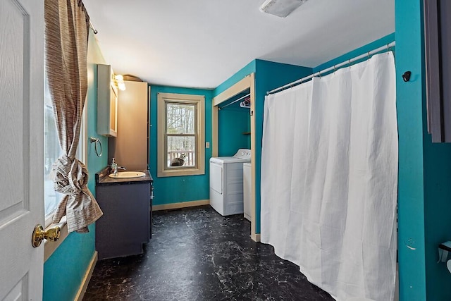 16 Libby Hill Rd, Gardiner, ME 04345 - bathroom featuring washer and clothes dryer, baseboards, vanity, finished concrete floors, and curtained shower