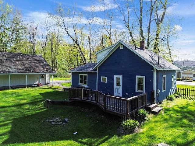 16 Libby Hill Rd, Gardiner, ME 04345 - rear view of house with a chimney, a yard, a wooden deck, and a shingled roof