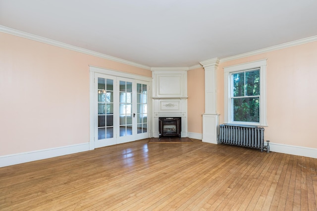 493 Main St, Eliot, ME 03903 - unfurnished living room with radiator, light wood finished floors, crown molding, baseboards, and a fireplace