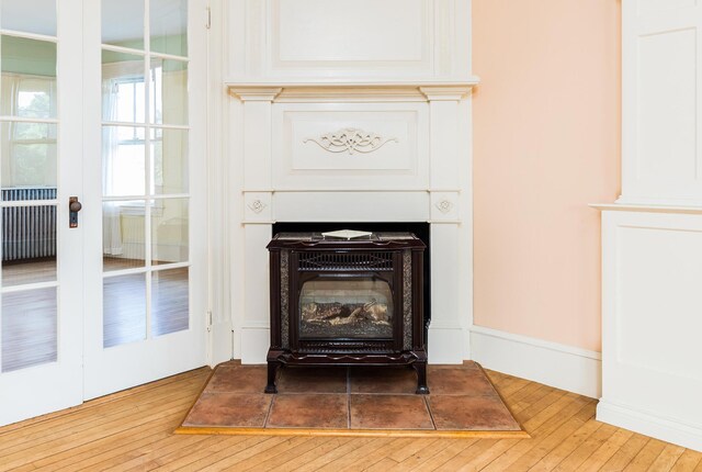 493 Main St, Eliot, ME 03903 - detailed view of wood finished floors and radiator heating unit