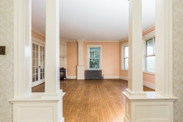493 Main St, Eliot, ME 03903 - unfurnished living room with radiator, light wood finished floors, wallpapered walls, ornamental molding, and baseboards