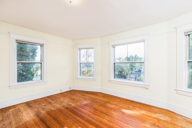 493 Main St, Eliot, ME 03903 - empty room featuring hardwood / wood-style flooring, healthy amount of natural light, and baseboards