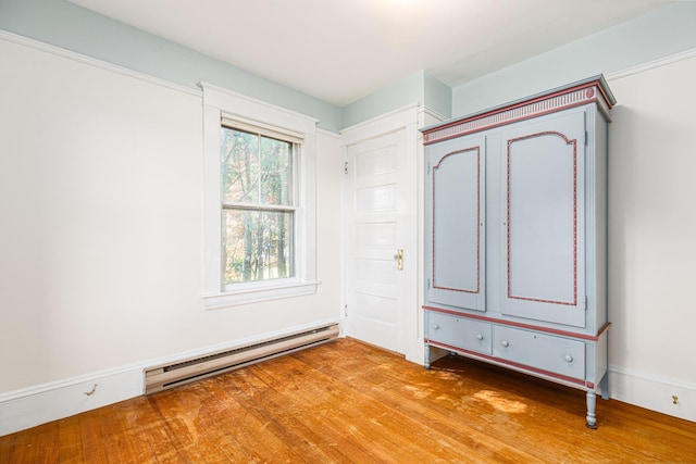 493 Main St, Eliot, ME 03903 - unfurnished bedroom featuring a baseboard heating unit and light wood finished floors