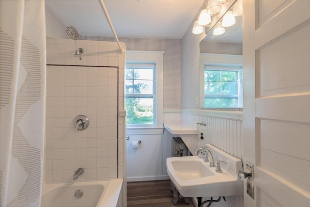 493 Main St, Eliot, ME 03903 - bathroom with a sink, a wainscoted wall, shower / bath combination with curtain, wood finished floors, and plenty of natural light