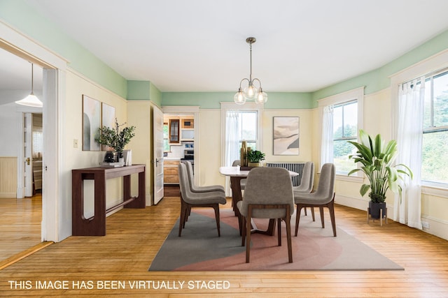 493 Main St, Eliot, ME 03903 - dining space with hardwood / wood-style flooring, plenty of natural light, and a chandelier