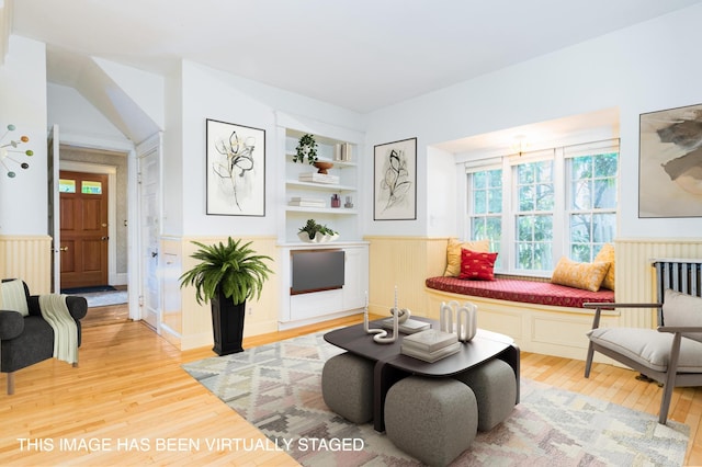 493 Main St, Eliot, ME 03903 - living area with a wainscoted wall, light wood finished floors, and built in features