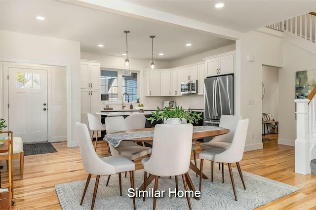 dining area with recessed lighting, baseboards, and light wood-style floors