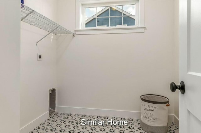 laundry area featuring laundry area, baseboards, and hookup for an electric dryer