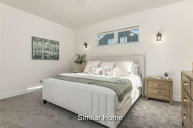 bedroom featuring light colored carpet and baseboards