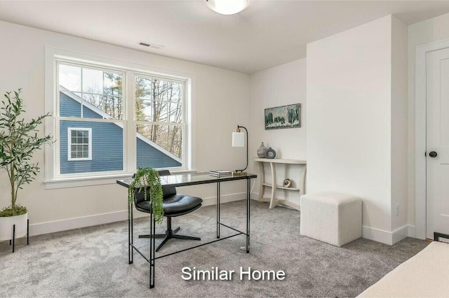 carpeted home office featuring baseboards, visible vents, and a wealth of natural light