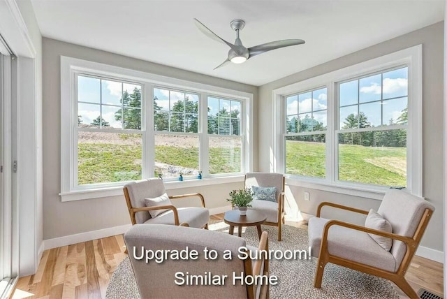 sunroom / solarium with a ceiling fan, visible vents, and a wealth of natural light