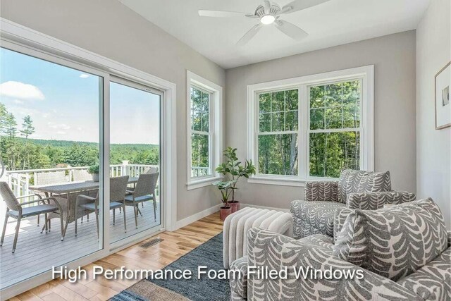 sunroom featuring visible vents and ceiling fan