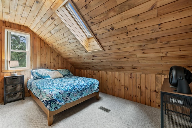 carpeted bedroom featuring visible vents, wood walls, and wood ceiling