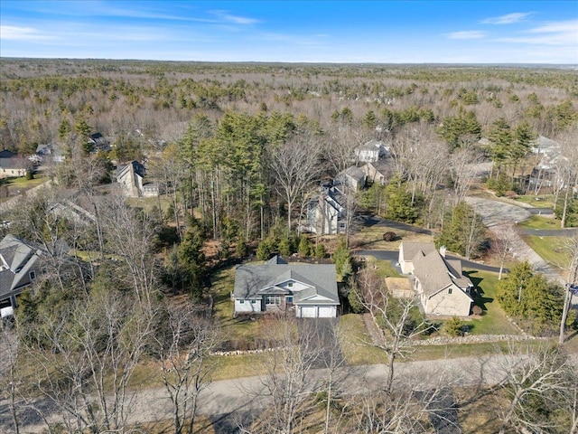 drone / aerial view featuring a forest view