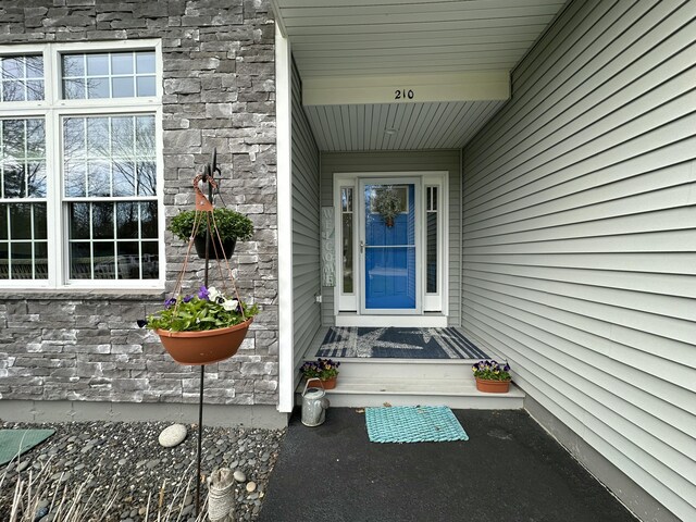 property entrance with stone siding