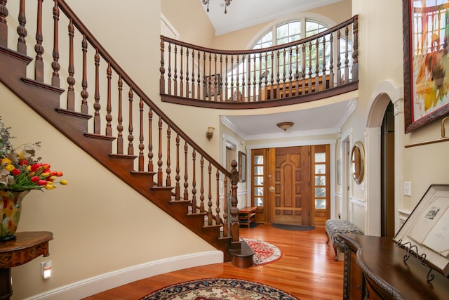 8 Spruce Point Rd, Kittery, ME 03904 - foyer entrance with stairs, wood finished floors, arched walkways, a towering ceiling, and ornamental molding