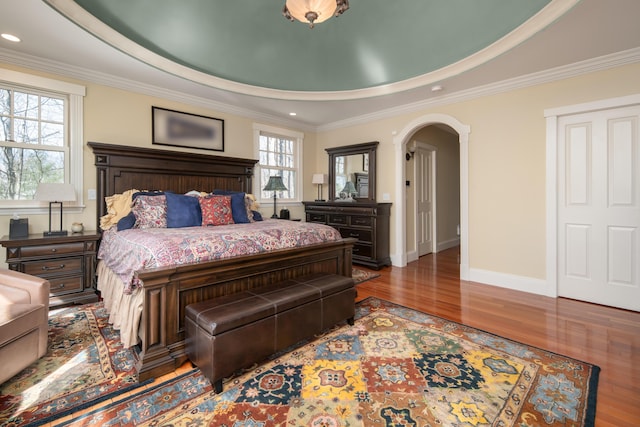 8 Spruce Point Rd, Kittery, ME 03904 - bedroom featuring arched walkways, a tray ceiling, baseboards, and wood finished floors