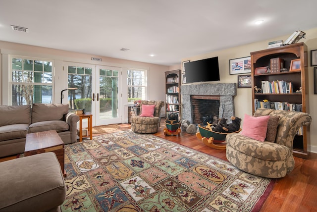 8 Spruce Point Rd, Kittery, ME 03904 - living room with visible vents, wood finished floors, french doors, and a stone fireplace