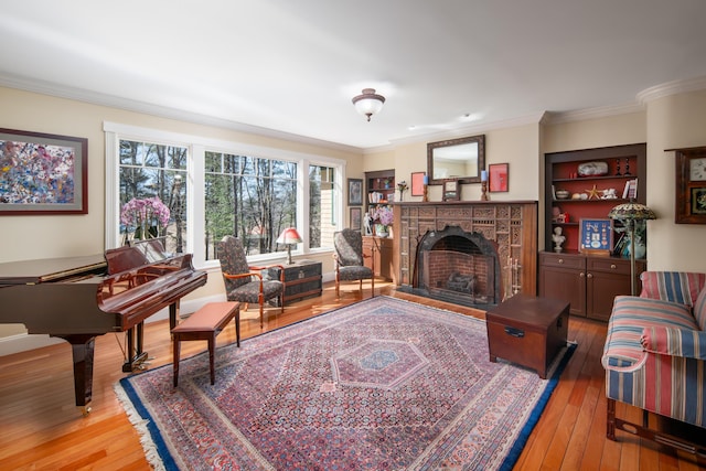 8 Spruce Point Rd, Kittery, ME 03904 - living room featuring built in features, a fireplace, crown molding, and light wood finished floors