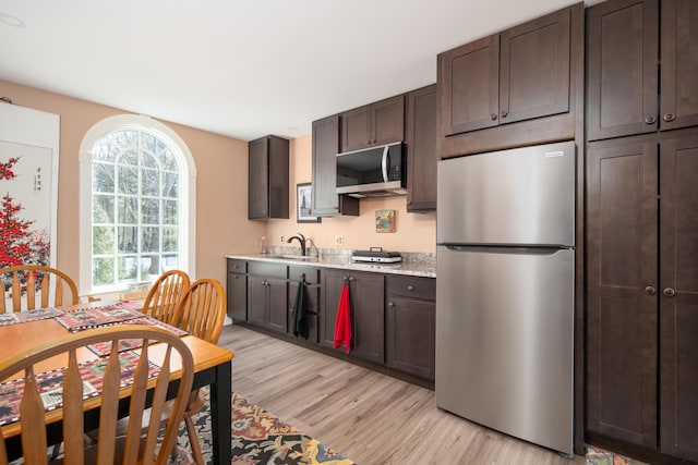 8 Spruce Point Rd, Kittery, ME 03904 - kitchen with dark brown cabinetry, a sink, stainless steel appliances, and light wood-type flooring