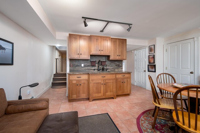 8 Spruce Point Rd, Kittery, ME 03904 - kitchen featuring light tile patterned floors, dark stone countertops, baseboards, decorative backsplash, and a sink