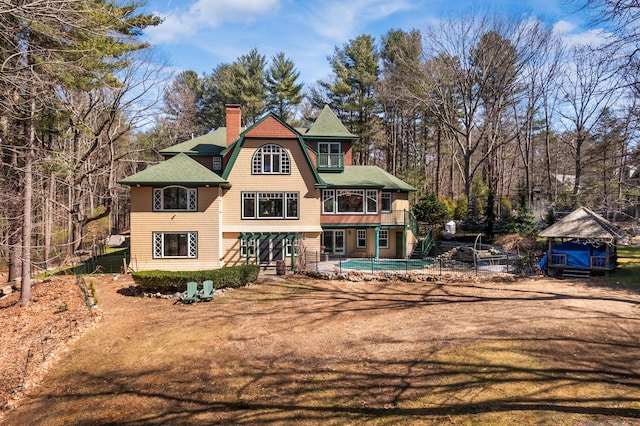 8 Spruce Point Rd, Kittery, ME 03904 - rear view of house featuring a chimney, an outdoor pool, and fence