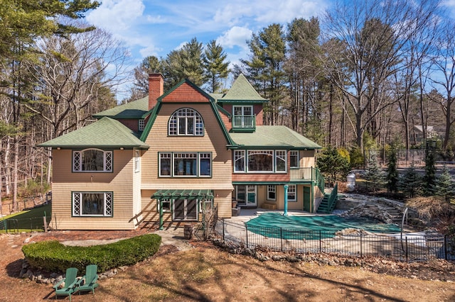 8 Spruce Point Rd, Kittery, ME 03904 - back of house with stairs, a fenced in pool, a chimney, fence, and a patio