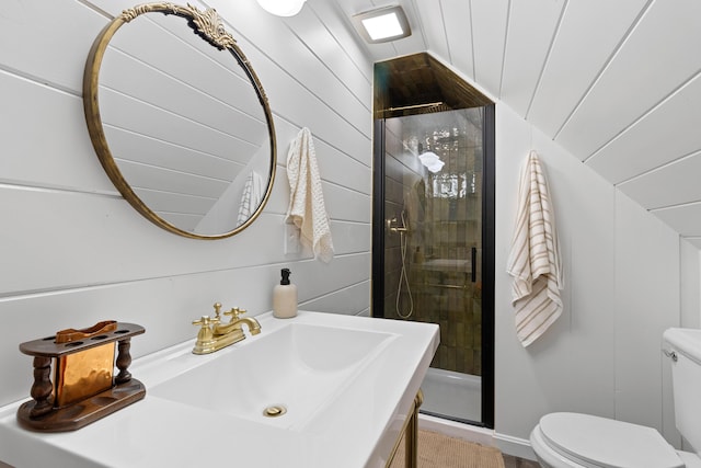 full bathroom with toilet, a sink, lofted ceiling, and a stall shower