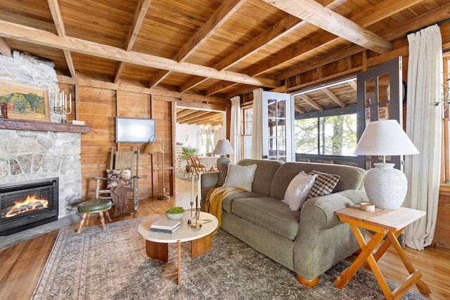 living area featuring a healthy amount of sunlight, wood ceiling, and beam ceiling