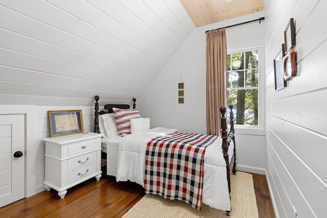 bedroom with dark wood finished floors, wood ceiling, and vaulted ceiling
