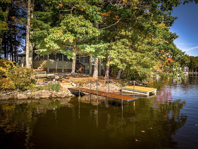 dock area featuring a water view and stairway