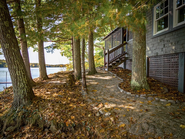 view of yard featuring a water view and stairs