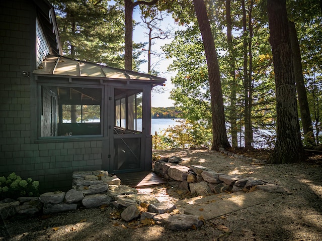 exterior space featuring a water view and a sunroom