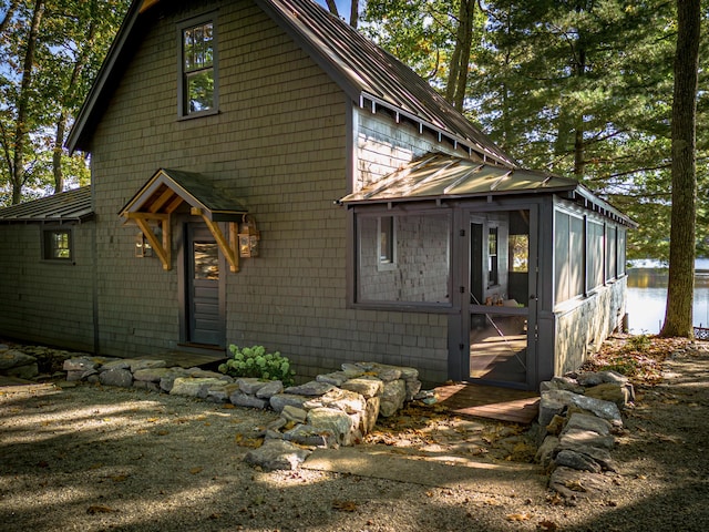 view of front facade featuring a sunroom and metal roof