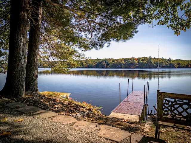 dock area featuring a water view and a wooded view