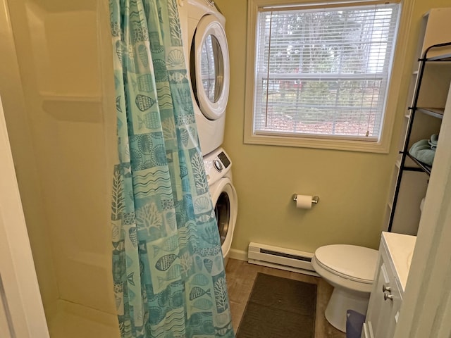 25 Garland Rd, Casco, ME 04015 - full bath featuring wood finished floors, curtained shower, a baseboard heating unit, stacked washer / dryer, and toilet