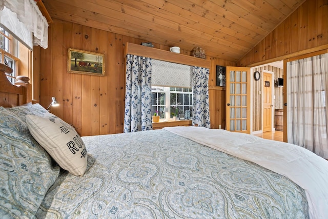 663 Eastbrook Rd, Eastbrook, ME 04634 - bedroom with lofted ceiling, wood walls, and wooden ceiling