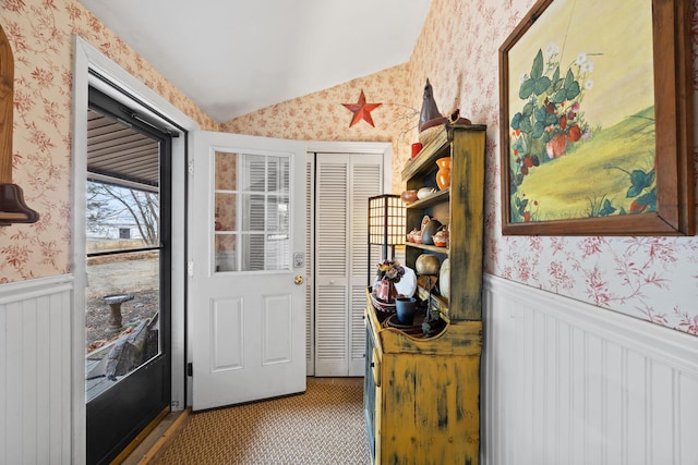 663 Eastbrook Rd, Eastbrook, ME 04634 - doorway featuring wallpapered walls, a wainscoted wall, and lofted ceiling