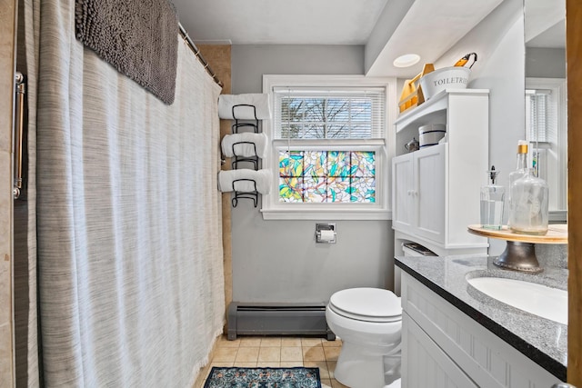 663 Eastbrook Rd, Eastbrook, ME 04634 - full bath with a baseboard radiator, tile patterned flooring, toilet, vanity, and curtained shower