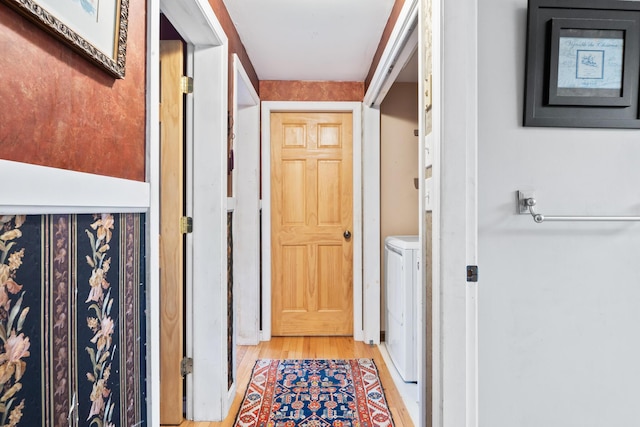663 Eastbrook Rd, Eastbrook, ME 04634 - hall featuring washing machine and dryer and light wood finished floors