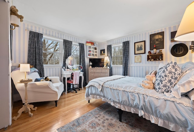 663 Eastbrook Rd, Eastbrook, ME 04634 - bedroom with wallpapered walls, hardwood / wood-style flooring, and crown molding